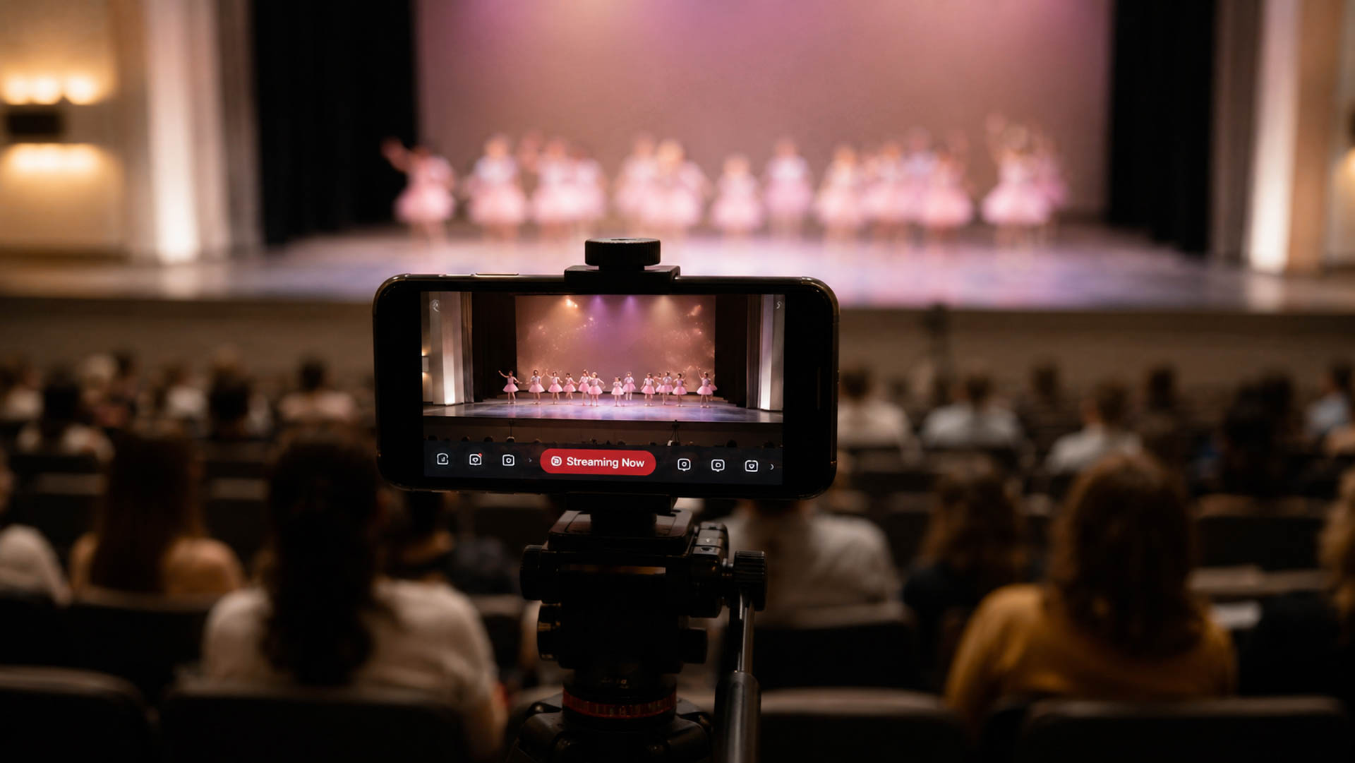 A videographer filming a dance recital
